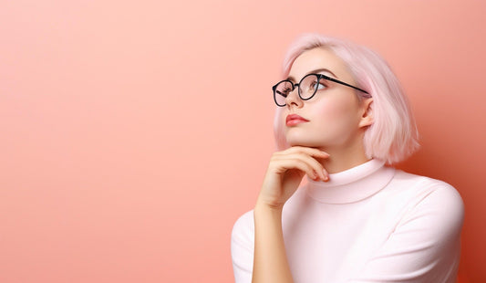 Young thoughtful girl on a pink background